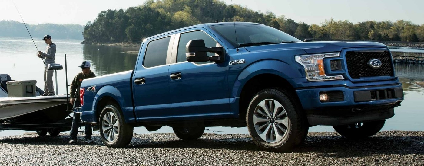 Blue 2018 Ford F-150 STX towing a fishing boat
